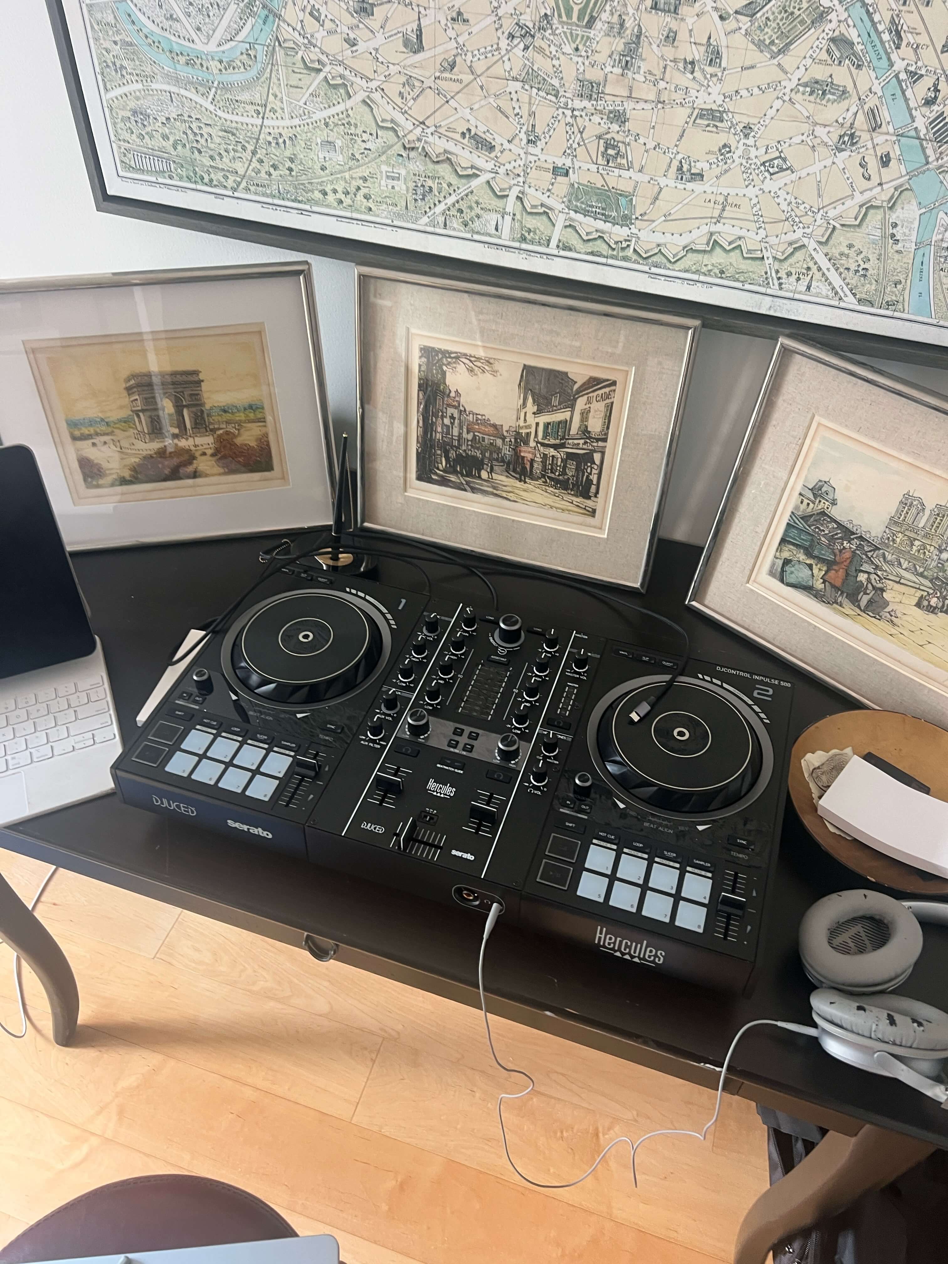 Michel’s DJ setup beside framed Paris artwork